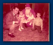 Gil with his daughter Cindy and his son Bruce with Dave and Santa in 1956